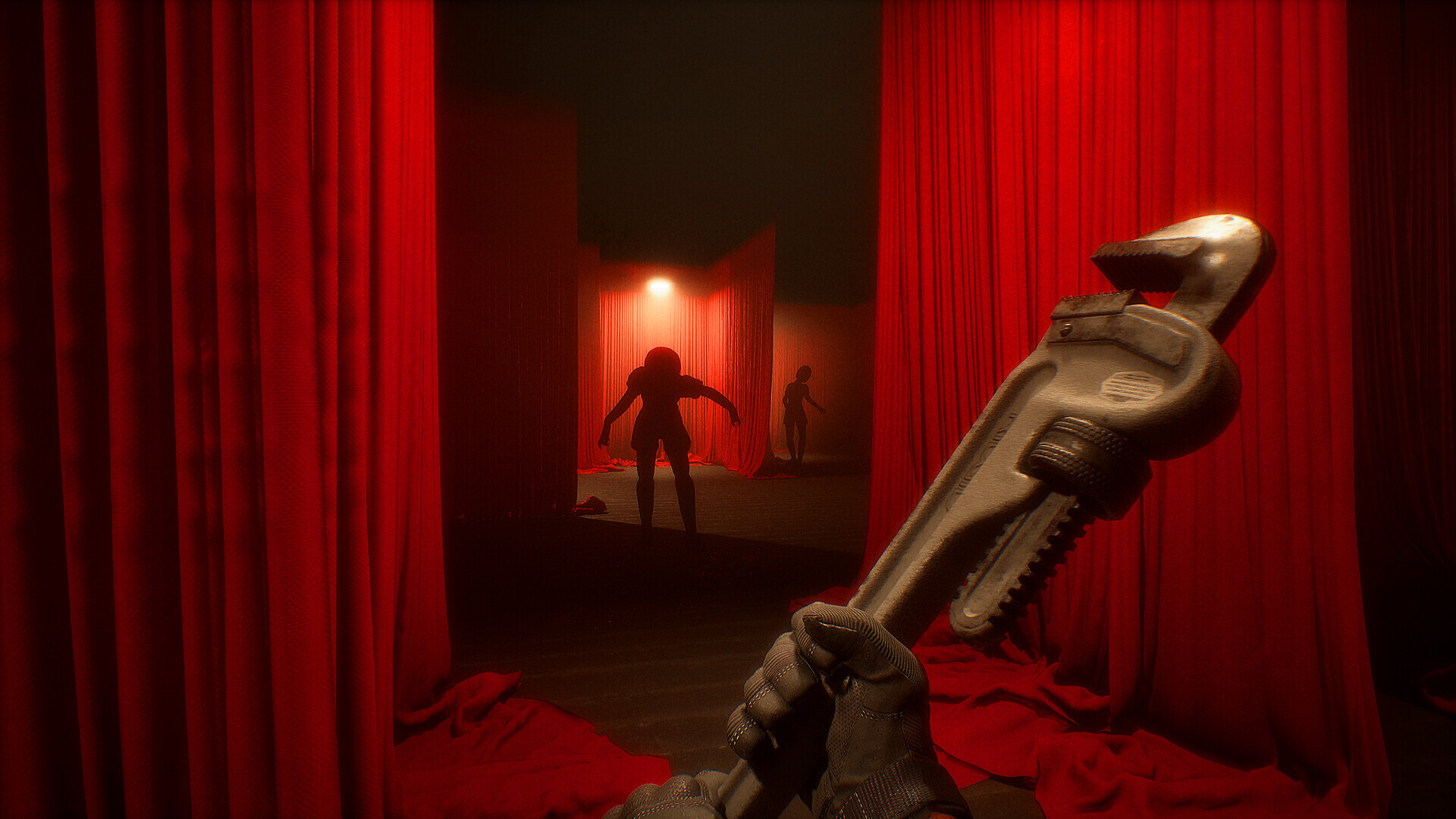 Deep red theatre curtains opening onto a dark corridor where two silhouetted figures stand, seen past a gloved hand holding a bone carving.